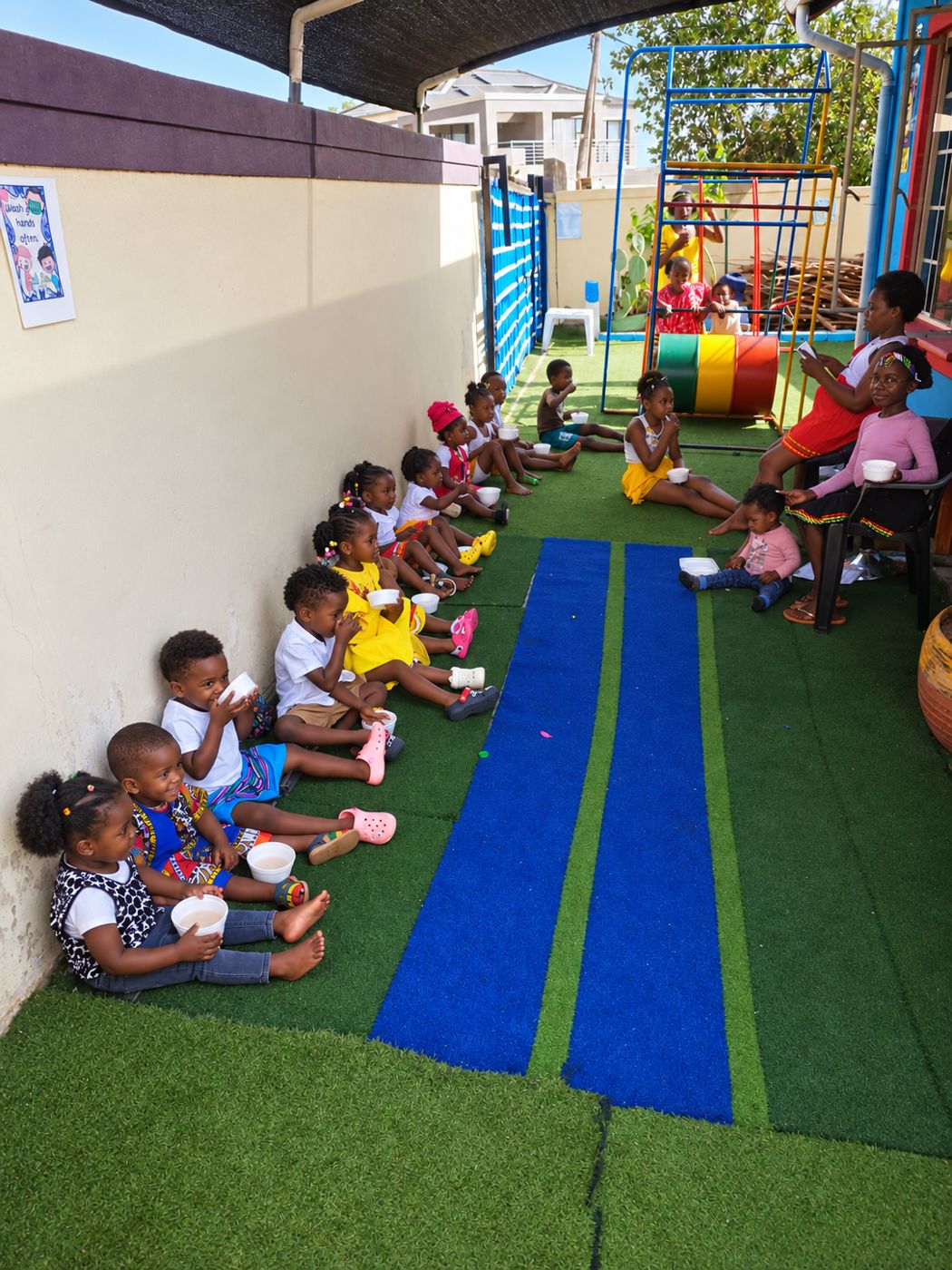 Children enjoying snack time on the play area